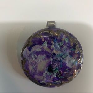 Pendant hand made ,2" round,purple with pink blue and white. Many layers to it.
